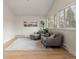 Bright living room featuring wood floors, comfortable seating, large windows, and a tranquil atmosphere at 712 S Longmont Ave, Lafayette, CO 80026
