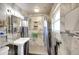 Nicely remodeled bathroom featuring tiled walk-in shower, and pedestal sink at 2694 S Krameria St, Denver, CO 80222