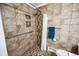 Accessible bathroom featuring tiled walk-in shower, safety bar, and in-wall storage niches at 2694 S Krameria St, Denver, CO 80222
