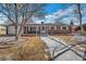 Charming brick home with a covered porch, manicured lawn, and inviting walkway at 2694 S Krameria St, Denver, CO 80222