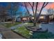 Beautiful exterior with manicured lawn, mature tree, and inviting walkway at sunset at 2694 S Krameria St, Denver, CO 80222