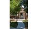 Charming brick home with landscaped front yard, sidewalk and covered porch at 2694 S Krameria St, Denver, CO 80222