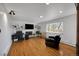 Bright living room featuring a fireplace, hardwood floors, and a large window for natural light at 2694 S Krameria St, Denver, CO 80222