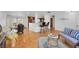 Bright open-concept living room with hardwood floors, breakfast bar, and adjacent dining area at 2694 S Krameria St, Denver, CO 80222