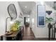 Inviting entryway featuring modern decor, stylish lighting, and wood floors that create a warm and welcoming ambiance at 1031 White Leaf Cir, Castle Rock, CO 80108