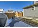 Backyard features a small concrete patio, fenced yard with rock and grass at 10196 Worchester St, Commerce City, CO 80022