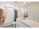 Bright bathroom features a tub and shower combination, white vanity, and neutral finishes at 10196 Worchester St, Commerce City, CO 80022