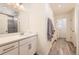 Bright bathroom with a white vanity, patterned shower, and modern fixtures, offering a clean and stylish design at 10196 Worchester St, Commerce City, CO 80022