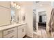 Stylish bathroom with a white vanity, modern fixtures, and a shower featuring decorative tiles, adding a touch of elegance at 10196 Worchester St, Commerce City, CO 80022