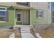 Close-up of a charming home's entrance with a well-maintained green exterior and stone landscaping at 10196 Worchester St, Commerce City, CO 80022