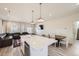 Open-concept kitchen featuring a large island, stainless steel appliances, and an adjacent living area at 10196 Worchester St, Commerce City, CO 80022