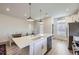 Bright kitchen with white cabinets, island, stainless steel appliances, and a dining area at 10196 Worchester St, Commerce City, CO 80022