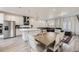 Open-concept kitchen and dining area with stainless steel appliances and a large center island at 10196 Worchester St, Commerce City, CO 80022