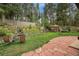 Lush backyard featuring a charming gazebo, serene waterfall, and stone patio, perfect for outdoor relaxation and entertaining at 29832 Dorothy Rd, Evergreen, CO 80439