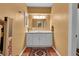 A well-lit bathroom with a vanity, mirror, and unique textured walls at 29832 Dorothy Rd, Evergreen, CO 80439