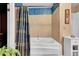 Bright bathroom featuring a white bathtub with whirlpool jets and a decorative shower curtain at 29832 Dorothy Rd, Evergreen, CO 80439