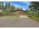 Large, well-maintained garage showcasing ample parking and storage space, blending functionality with exterior aesthetics at 29832 Dorothy Rd, Evergreen, CO 80439