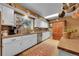 A cozy kitchen with stainless steel appliances, a large sink, and a vintage rug at 29832 Dorothy Rd, Evergreen, CO 80439