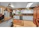 Bright kitchen with white cabinets, a skylight, stainless steel appliances, and an island at 29832 Dorothy Rd, Evergreen, CO 80439