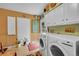 A bright laundry room with front-loading washer and dryer and inspirational wall art at 29832 Dorothy Rd, Evergreen, CO 80439
