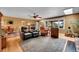 Living room featuring hardwood floors, fireplace, and views into dining room at 29832 Dorothy Rd, Evergreen, CO 80439