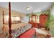 Spacious primary bedroom with beautiful furnishings, wooden bed frame, and ample lighting at 29832 Dorothy Rd, Evergreen, CO 80439