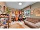 Charming home office with a cozy couch, built-in desk, and natural light from a window at 29832 Dorothy Rd, Evergreen, CO 80439