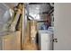 Utility room with modern water heater, furnace, and a washing machine for in-house laundry convenience at 29832 Dorothy Rd, Evergreen, CO 80439