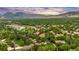 Gorgeous aerial view of property surrounded by lush landscaping and community with mountain views at 3807 Paseo Del Prado, Boulder, CO 80301