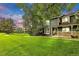 Inviting home with well-manicured lawn, stone accents, and lush trees creates a welcoming curb appeal at 3807 Paseo Del Prado, Boulder, CO 80301