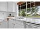 A closer view of the kitchen sink with a large window above and stainless steel appliances at 3807 Paseo Del Prado, Boulder, CO 80301