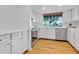Bright kitchen with white cabinetry, modern appliances, and hardwood floors is sure to impress at 3807 Paseo Del Prado, Boulder, CO 80301
