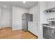 Additional kitchen view with stainless steel refrigerator, cabinets, and hardwood floors at 3807 Paseo Del Prado, Boulder, CO 80301