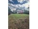 Large backyard with spacious lawn, wood fence, and deck, perfect for outdoor living at 2551 W 58Th W Ave, Denver, CO 80221