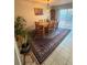Dining room featuring a wooden table and chairs set, complemented by elegant floor rug at 2551 W 58Th W Ave, Denver, CO 80221