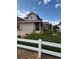 Charming home with manicured lawn, white picket fence, and stone accents on the facade at 2551 W 58Th W Ave, Denver, CO 80221