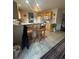 Open kitchen with wood cabinets, breakfast bar, tile floor, and access to the backyard at 2551 W 58Th W Ave, Denver, CO 80221