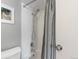 Close-up of bathroom shower with white tiled walls and neutral shower curtain at 1090 N Lafayette St # 503, Denver, CO 80218