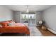 Comfortable bedroom with balcony, hardwood floors, natural light and light gray walls at 1090 N Lafayette St # 503, Denver, CO 80218