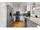 Galley kitchen with stainless steel appliances, white cabinets, and dark backsplash at 1090 N Lafayette St # 503, Denver, CO 80218
