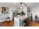 Modern kitchen with stainless steel appliances, white cabinets, marble countertop, and counter seating at 1090 N Lafayette St # 503, Denver, CO 80218
