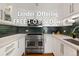 Well-lit kitchen features stainless steel appliances, white cabinetry, dark backsplash, and quartz countertops at 1090 N Lafayette St # 503, Denver, CO 80218