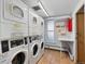 Bright community laundry room featuring multiple washers, dryers, and a utility sink for residents' convenience at 1090 N Lafayette St # 503, Denver, CO 80218