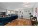 Open-concept living room with hardwood floors, modern lighting, and access to a balcony at 1090 N Lafayette St # 503, Denver, CO 80218