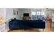 Cozy living room with a comfortable blue sofa, entertainment center, and bright balcony access at 1090 N Lafayette St # 503, Denver, CO 80218