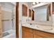 Bathroom featuring double sink vanity, mirror, shower over tub combination, and good lighting at 18874 E Colorado Dr, Aurora, CO 80017