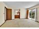 Bright carpeted bedroom with backyard view through sliding glass door and access to bathroom at 18874 E Colorado Dr, Aurora, CO 80017