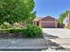 Charming single-story home with a well-maintained lawn and a spacious driveway under a clear, blue sky at 18874 E Colorado Dr, Aurora, CO 80017