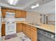 Functional kitchen with wood cabinets, modern appliances, and plenty of counter space for cooking at 18874 E Colorado Dr, Aurora, CO 80017