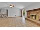 Bright living room featuring a brick fireplace, sliding glass doors, and neutral flooring at 18874 E Colorado Dr, Aurora, CO 80017